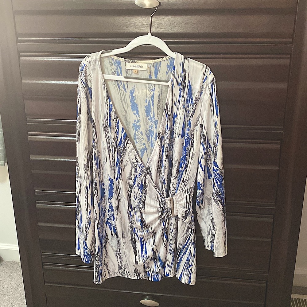 Wrap style top with silver buckle, polyester and spandex, wash gentle cycle